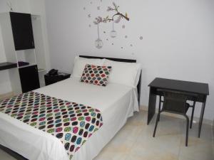 Ένα ή περισσότερα κρεβάτια σε δωμάτιο στο Hotel Cosmos Sincelejo