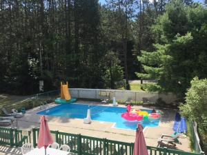 a swimming pool with inflatables in a backyard at High Falls Bay Cottages, Camping & Waterpark in Bracebridge