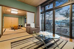 a living room with a chair and a glass table at White Horse Hotel in Hakuba