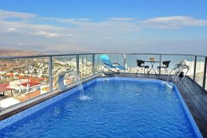 a swimming pool on the roof of a building at Luxury Suite with Jaccuzzi & Heated Pool in Tiberias