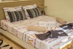A bed or beds in a room at Take your time Apartment
