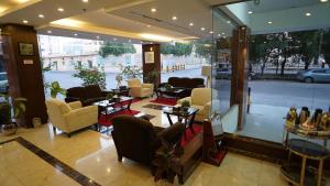 a lobby with couches and chairs in a building at Jowharet AlMaseya in Al Khobar
