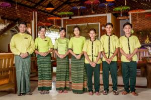 a group of people posing for a picture at Hotel Queen Jamadevi in Mawlamyine