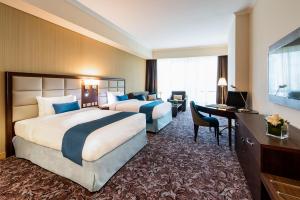 Gulta vai gultas numurā naktsmītnē Golden Tulip Doha Hotel