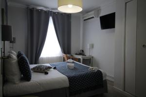 Postel nebo postele na pokoji v ubytování Régina Boutique Hotel