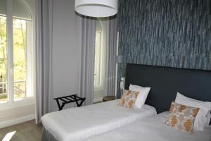 Postel nebo postele na pokoji v ubytování Régina Boutique Hotel