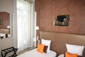 Postel nebo postele na pokoji v ubytování Régina Boutique Hotel