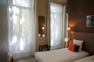 Postel nebo postele na pokoji v ubytování Régina Boutique Hotel