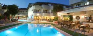 a swimming pool in front of a building with a restaurant at Ida Hotel in Marmaris