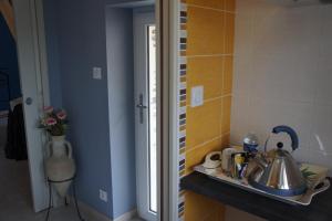 a kitchen with a sink and a counter with a tea kettle at La chambre du harpiste in Saint-Mars-la-Jaille