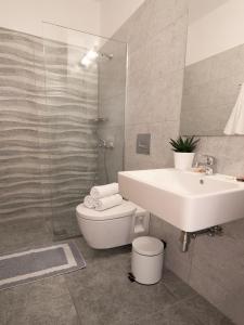a bathroom with a sink, toilet and bathtub at Melissa Apartments in Malia