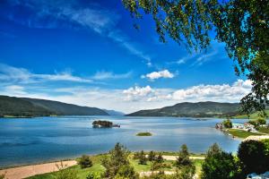 a large body of water with mountains in the background at Къща за гости Шотарови in Dospat