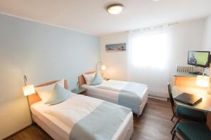 Postel nebo postele na pokoji v ubytování Residenz Hotel Wuppertal