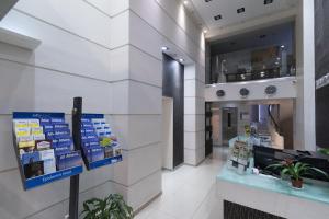 a lobby of a building with a pharmacy at Epidavros Hotel in Athens
