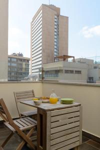 a table with bowls of food on a balcony at Apartment On Mapu Street in Tel Aviv