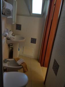 a bathroom with a sink and a toilet at Casolare Al Porto in Tropea