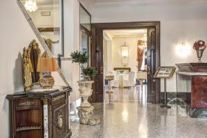 a hallway with vases and a table in a building at Hotel Castel Vecchio in Castel Gandolfo +123 photos