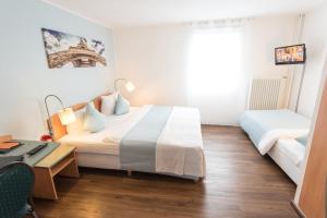 Postel nebo postele na pokoji v ubytování Residenz Hotel Wuppertal