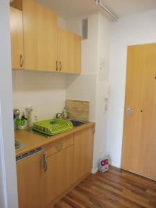 a kitchen with wooden cabinets and a counter top at Schnuckelig und Fein in Oberstaufen