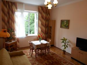 a living room with a table and a window at Apartament Krakowski Styl in Krakow
