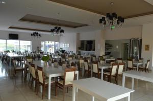 a dining room with white tables and chairs at Apartment nearby Golden Coast in Protaras