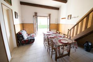 a dining room with a table and a chair at Sarl Aurore-Vacances in Vico