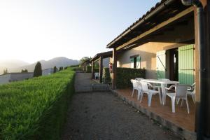 a patio with a table and chairs on a building at Sarl Aurore-Vacances in Vico