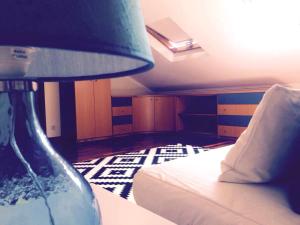 a bedroom with a bed and a table with a lamp at Apartment Vedória in Viana do Castelo +6 photos