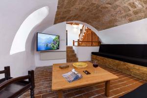 a living room with a table and a tv at Belvedere Medieval Villa in Rhodes Town