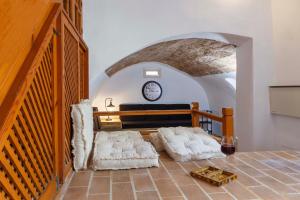 a living room with two white chairs and a clock at Belvedere Medieval Villa in Rhodes Town