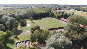 an aerial view of a park with a large field at Les Portes des Froises in Saint-Quentin-en-Tourmont