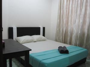 מיטה או מיטות בחדר ב-Al-Kahfi Homestay