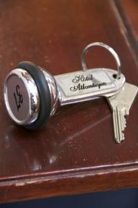 a key chain on top of a wooden table at Hotel Atlantique in Le Palais