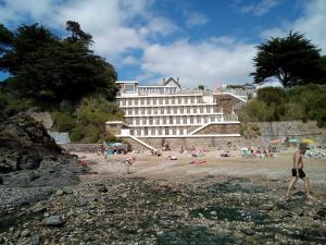 a group of people on a beach near a hotel at L'Ermitage in Pornic