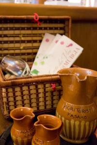 three vases sitting next to a basket on a table at Agriturismo Fasano in Cassano delle Murge