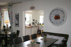 a dining room with two tables and chairs and a kitchen at CarlstadCity H Boutique Hotell in Karlstad