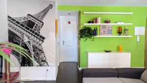 a living room with a couch and a eiffel tower mural at Los Caños - Parking opcional in Jaén