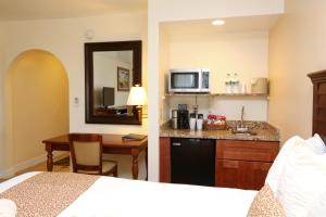 a hotel room with a bed and a kitchen at La Fiesta Ocean Inn & Suites in Saint Augustine Beach