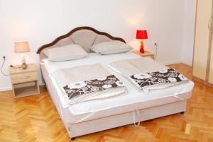 a bedroom with a bed with two pillows on it at Stan na dan in Banja Luka