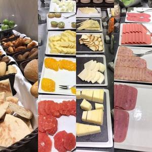 a table full of different types of cheese and meats at Petra Sella Hotel in Wadi Musa