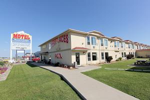 a large building with a sign in front of it at Western Budget Motel Bonnyville in Bonnyville