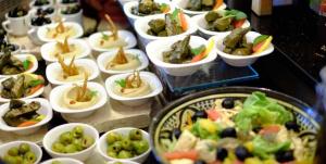 a bunch of appetizers in bowls on a buffet at Petra Sella Hotel in Wadi Musa