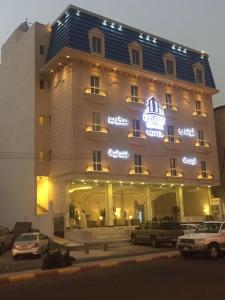 a large building with cars parked in front of it at Golden Square in Khamis Mushayt