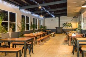 a restaurant with wooden tables and chairs and plants at Tarraleah Estate in Tarraleah