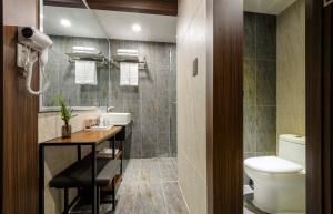 uma casa de banho com um lavatório e um WC em Hotel With Jeju em Jeju
