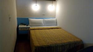 Postel nebo postele na pokoji v ubytování Reui Chung Hotel
