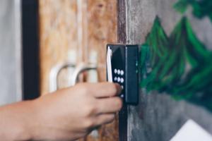 a person is unlocking a door with a cell phone at Rowhou8e Hostel Hua Hin 106 in Hua Hin
