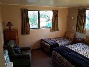 A bed or beds in a room at Serenity Motels