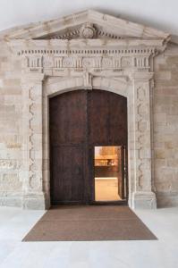 a doorway leading to a room with a large door at Parador de Lleida in Lleida