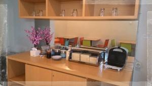 a kitchen counter with a toaster oven on it at SWK 95 Hotel in Surabaya